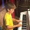 Young student of Cildren's piano lessons marbella, practising at the piano.