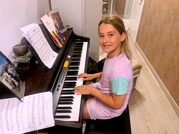 Child playing piano during a lesson at Marbella Piano Lessons